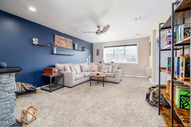 214 Westend Avenue, Unit 6C Freeport, NY 11520 - Photo 7 of 17 a living room with furniture a bookshelf and a window