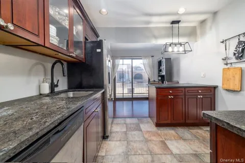 a kitchen with stainless steel appliances granite countertop a sink and stove