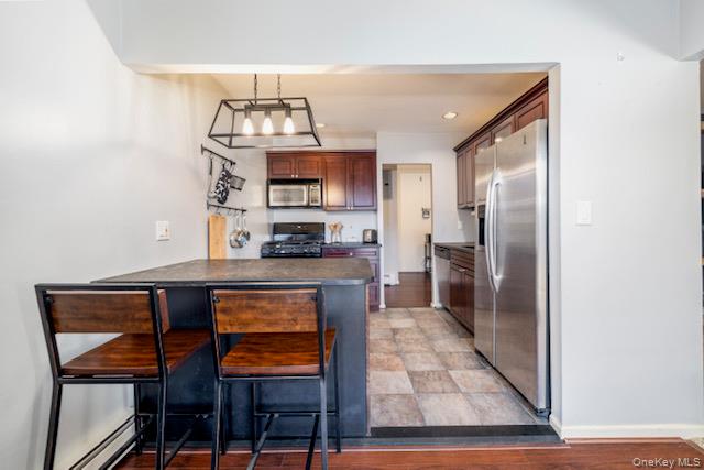 214 Westend Avenue, Unit 6C Freeport, NY 11520 - Photo 10 of 17 a kitchen with stainless steel appliances granite countertop a refrigerator a stove and a sink