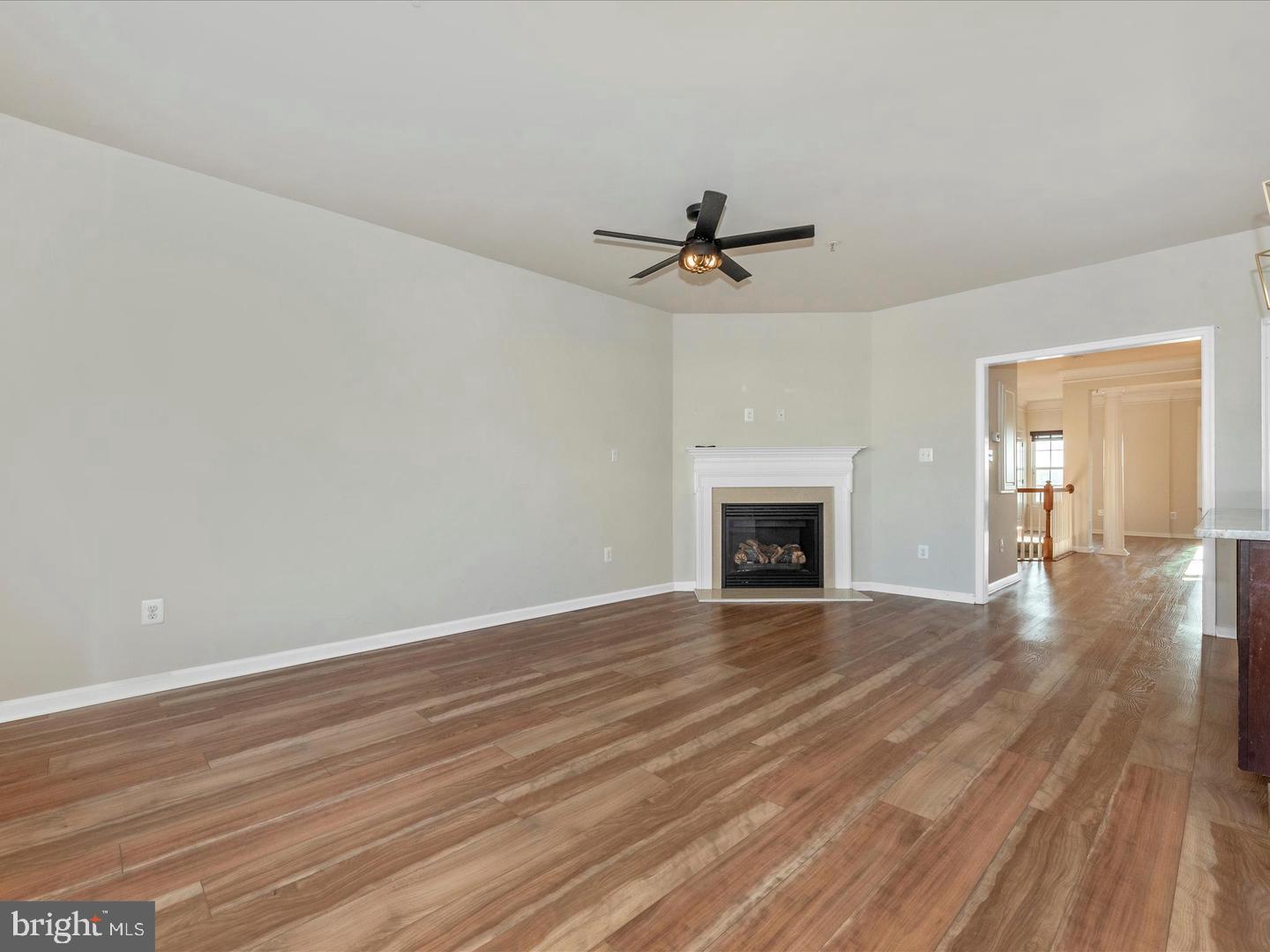208 B Mill Pond Road Frederick, MD 21701 - Photo 20 of 45 a view of empty room with wooden floor and fireplace