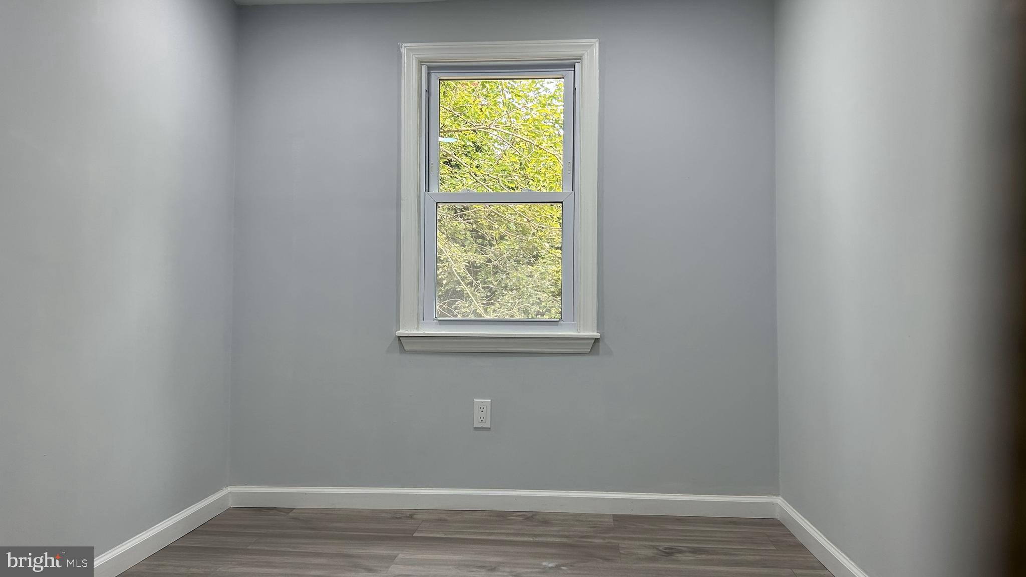 69 Carpenter Street Salem, NJ 08079 - Photo 19 of 29 a view of an empty room with wooden floor and a window