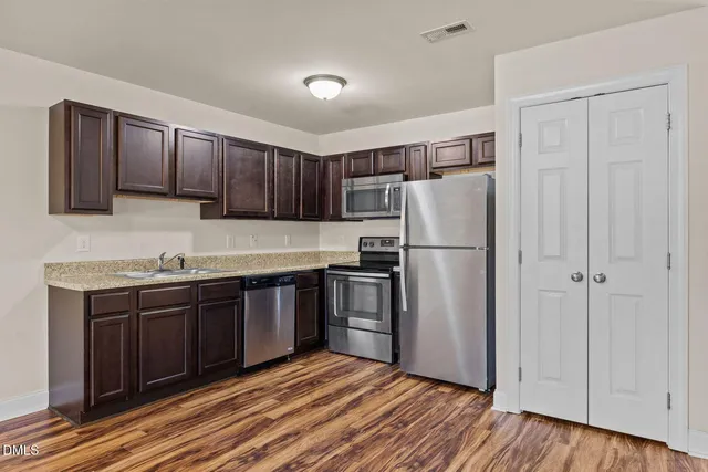 a view of kitchen and wooden floor