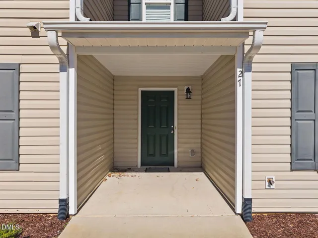 a view of a hallway with wooden floor and closet