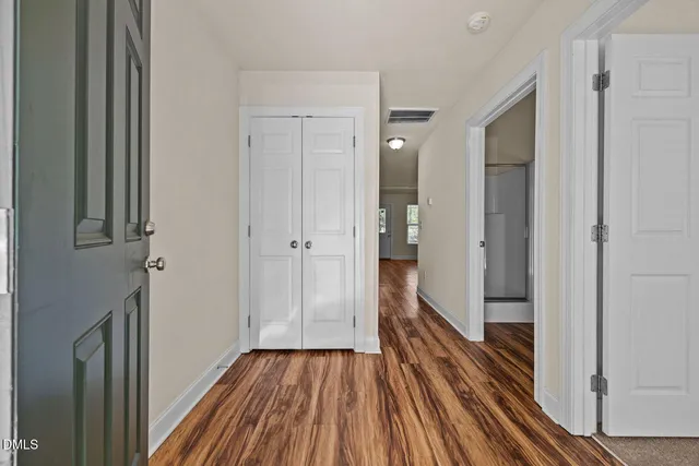 a view of a room with wooden floor