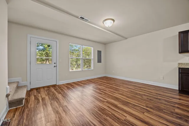 a view of kitchen with wooden floor and window