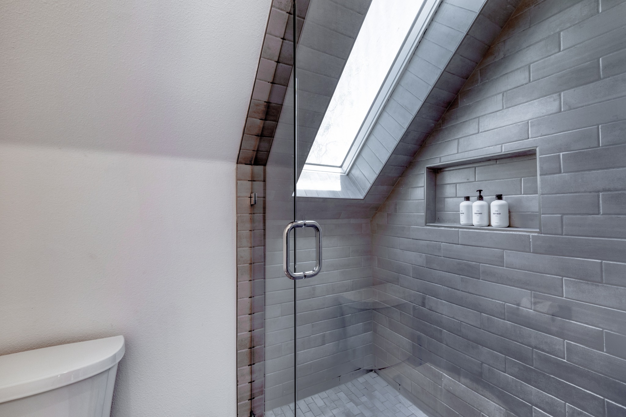 5406 Downs Drive, Unit 2 Austin, TX 78721 - Photo 19 of 24 a bathroom with a glass door shower