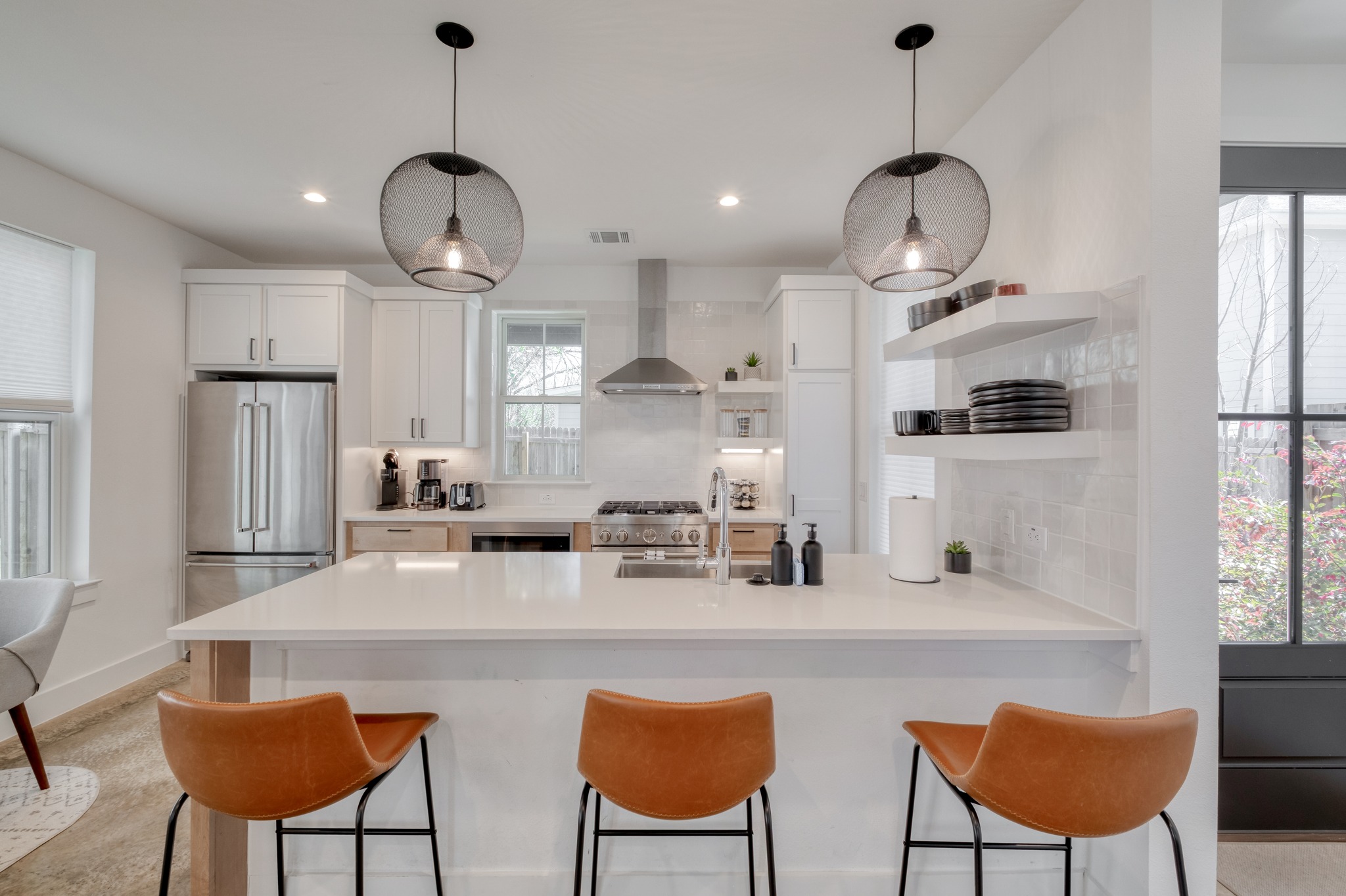 5406 Downs Drive, Unit 2 Austin, TX 78721 - Photo 2 of 24 a kitchen with stainless steel appliances a table chairs and a refrigerator