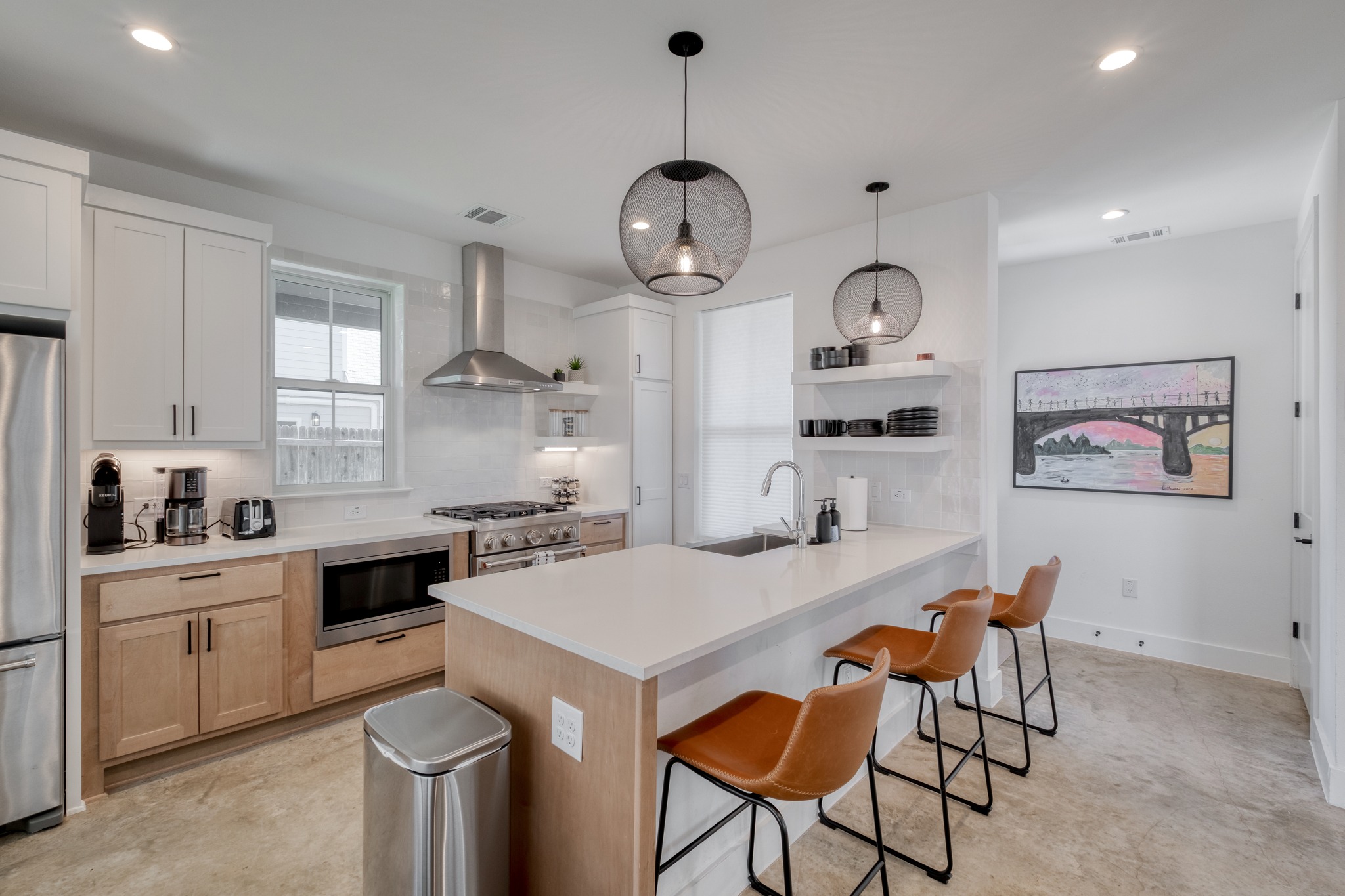 5406 Downs Drive, Unit 2 Austin, TX 78721 - Photo 4 of 24 a kitchen with a dining table chairs cabinets and stainless steel appliances