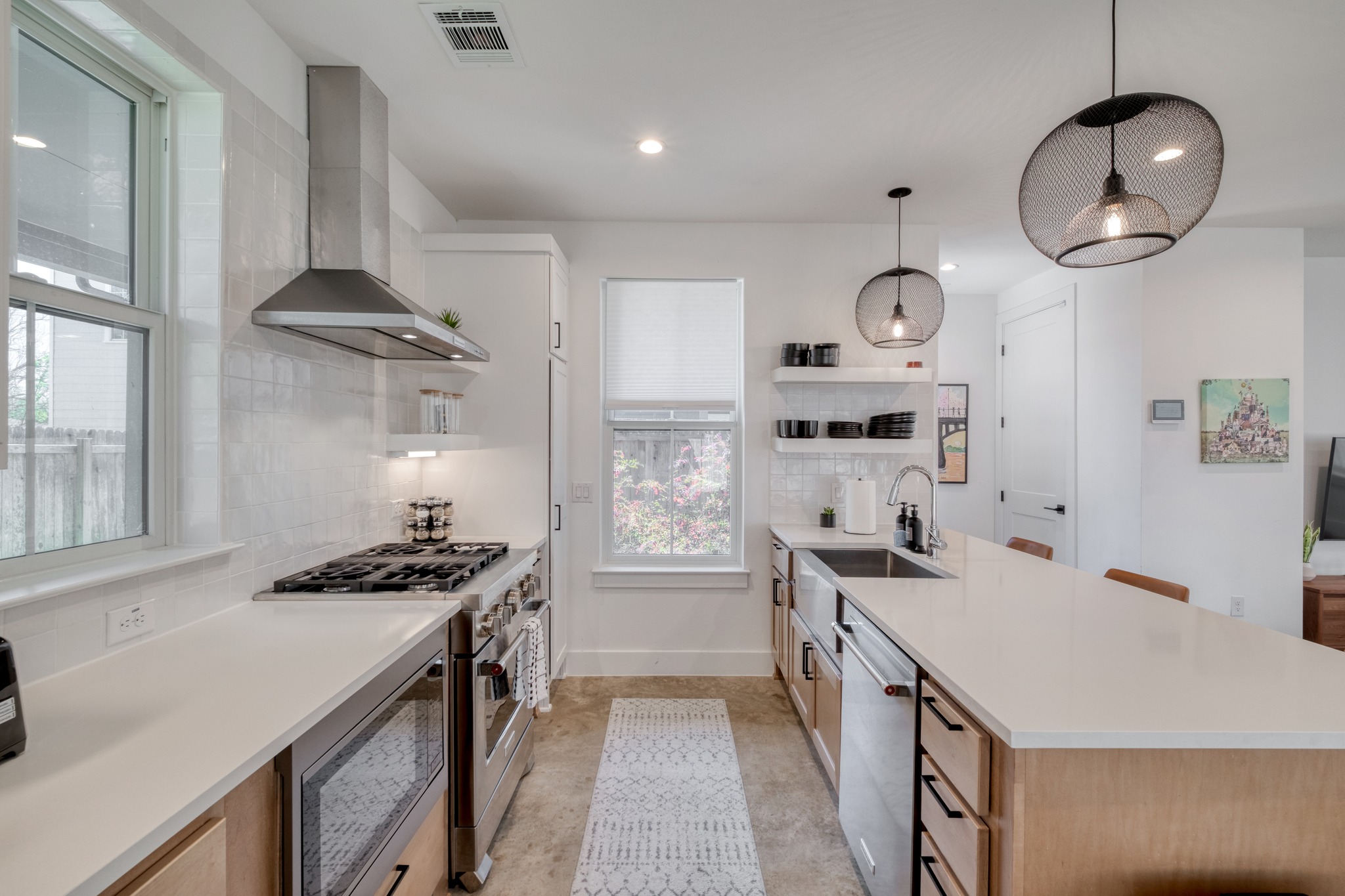5406 Downs Drive, Unit 2 Austin, TX 78721 - Photo 5 of 24 a kitchen with stainless steel appliances a stove a sink a refrigerator and cabinets