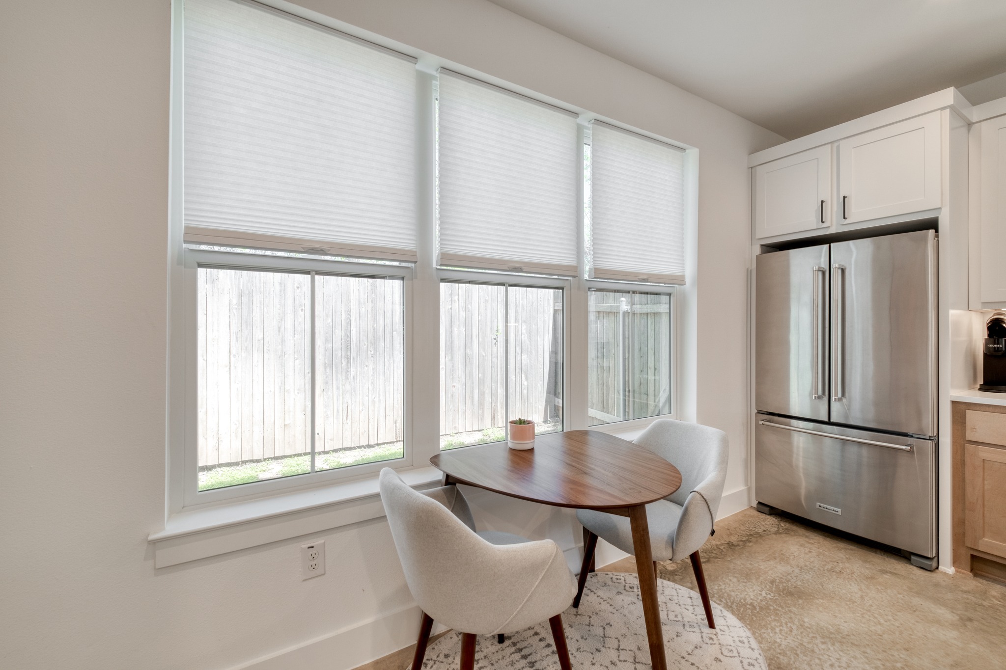 5406 Downs Drive, Unit 2 Austin, TX 78721 - Photo 8 of 24 a kitchen with a refrigerator a table and chairs in it