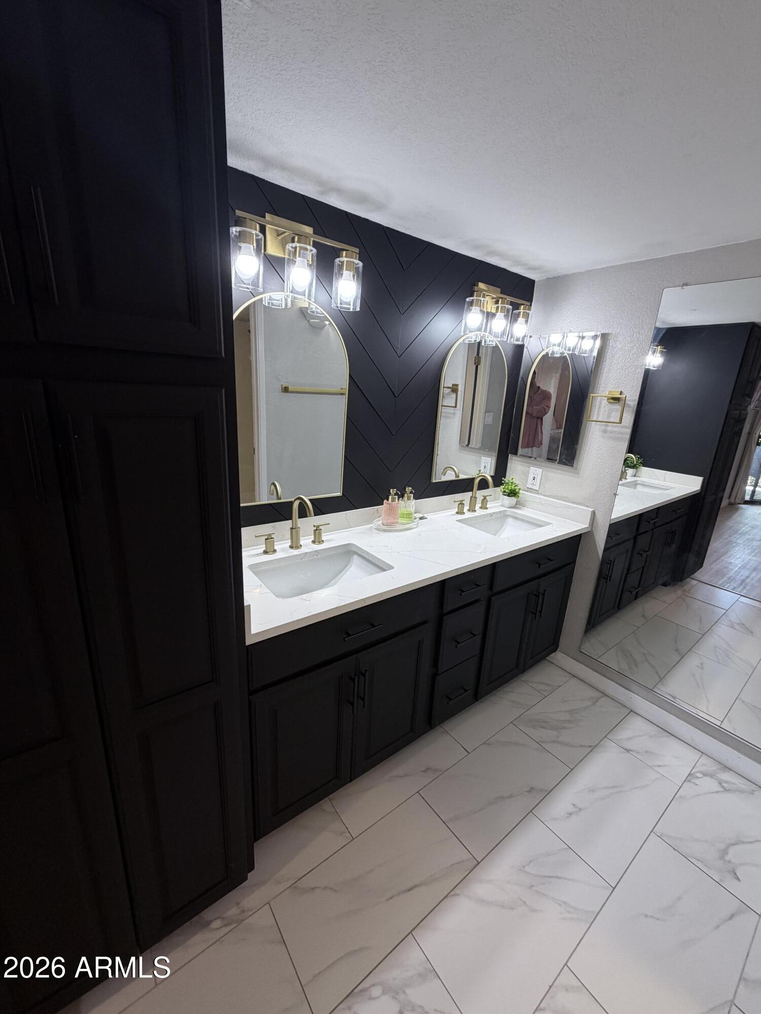 4303 East Cactus Road, Unit 128 Phoenix, AZ 85032 - Photo 30 of 39 a bathroom with a double vanity sink and a mirror