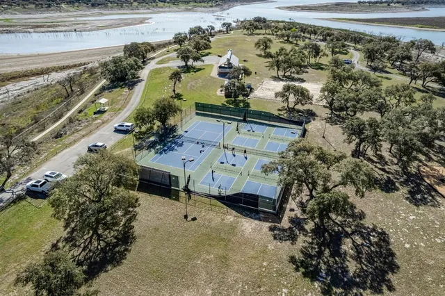 a view of a balcony with dining table and chairs