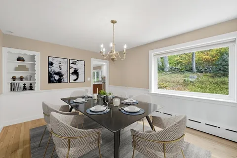 a dining room with furniture a window and a chandelier