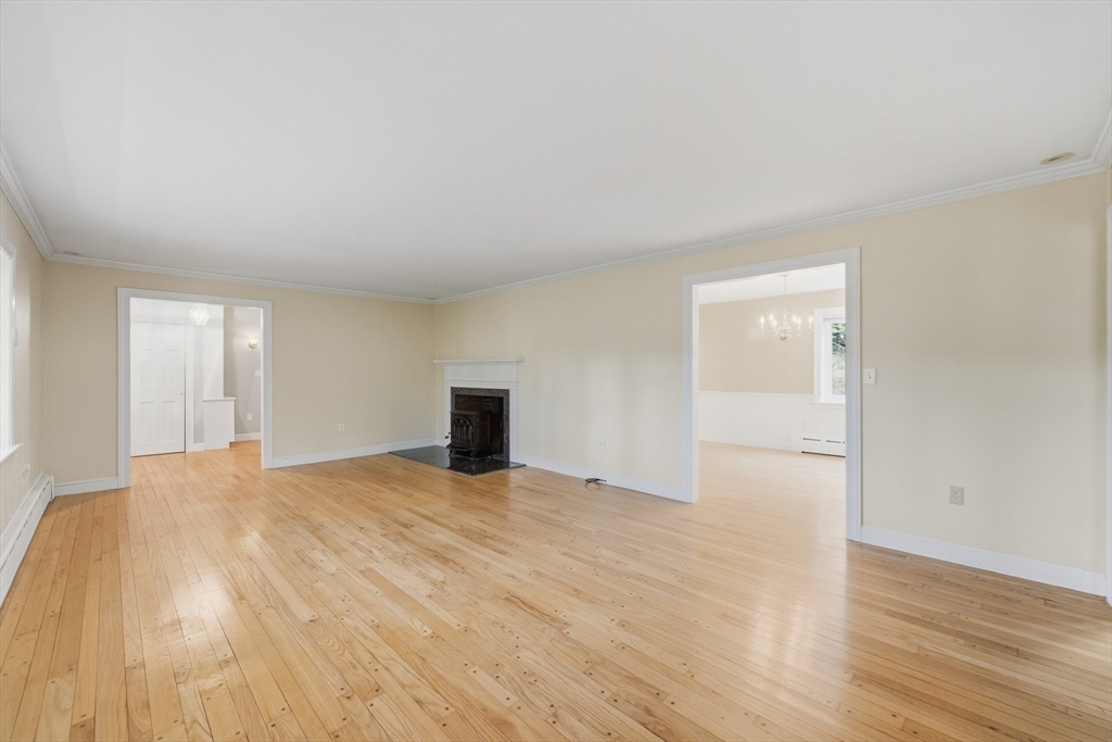 56 Century Mill Road Bolton, MA 01740 - Photo 19 of 41 a view of an empty room with wooden floor and windows