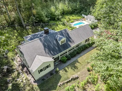 an aerial view of a house with outdoor space and street view