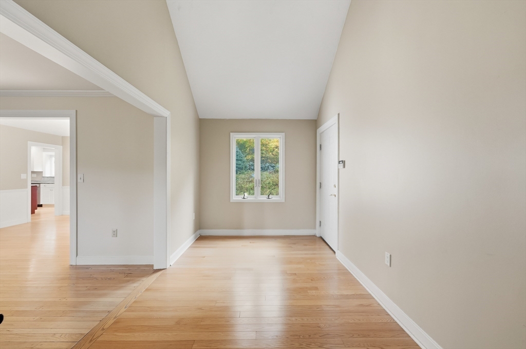 56 Century Mill Road Bolton, MA 01740 - Photo 21 of 41 a view of an empty room with wooden floor and a window