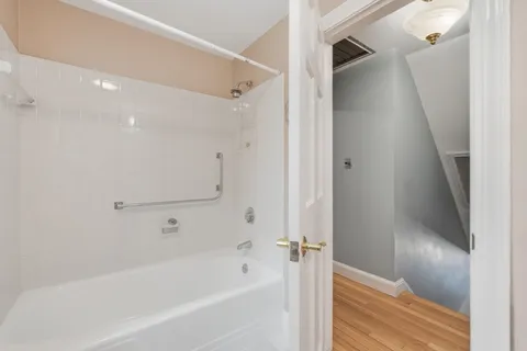 a bathroom with a bathtub and a shower