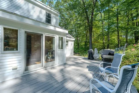 a view of a patio with table and chairs and wooden floor
