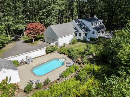 an aerial view of a house with yard swimming pool and outdoor seating