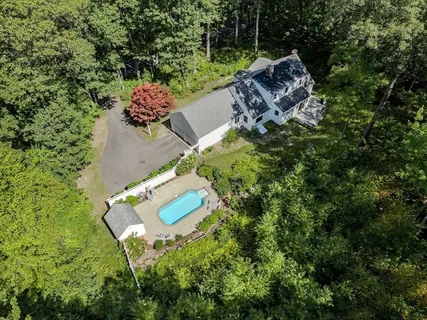 an aerial view of a house with a yard basket ball court and outdoor seating