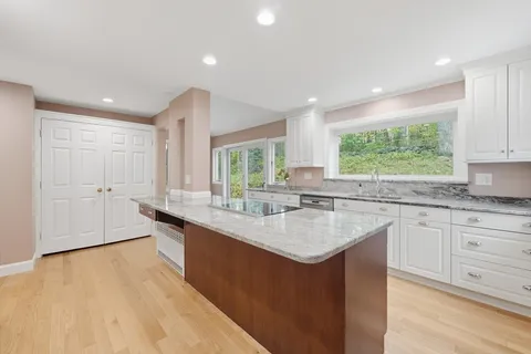 a kitchen with sink cabinets and wooden floor