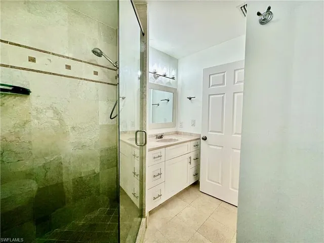 a bathroom with a double vanity sink and mirror