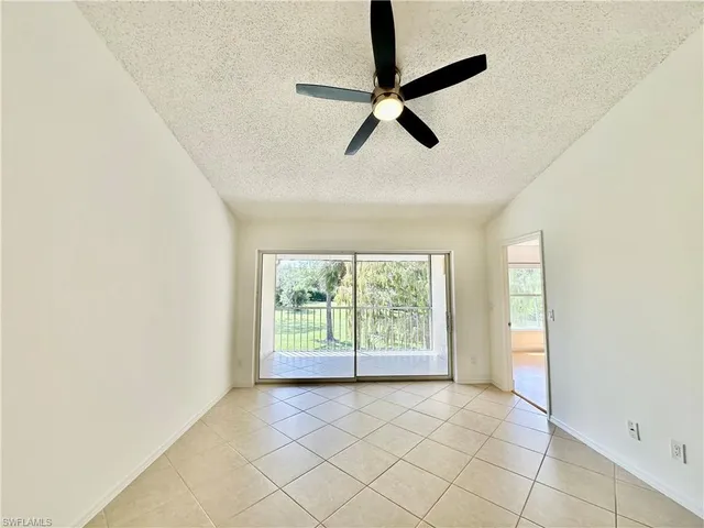a view of room with window and a ceiling fan