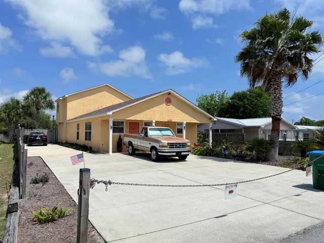 a car parked in front of house with a yard