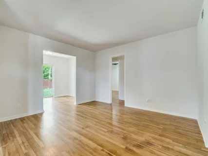 a view of an empty room and wooden floor