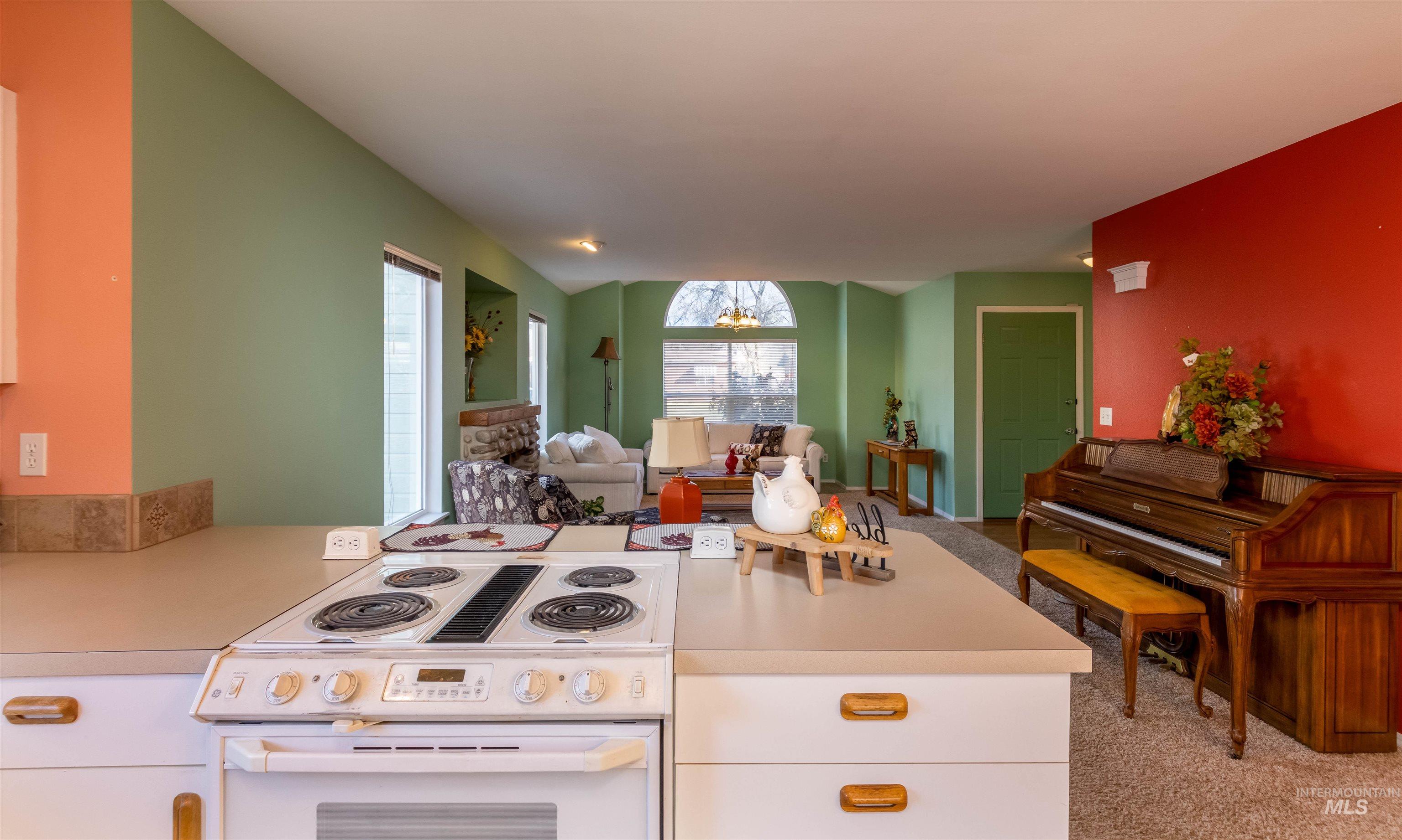 1811 Cleveland Street Boise, ID 83705 - Photo 30 of 30 Kitchen featuring white range with electric cooktop, light countertops, carpet floors, and open floor plan
