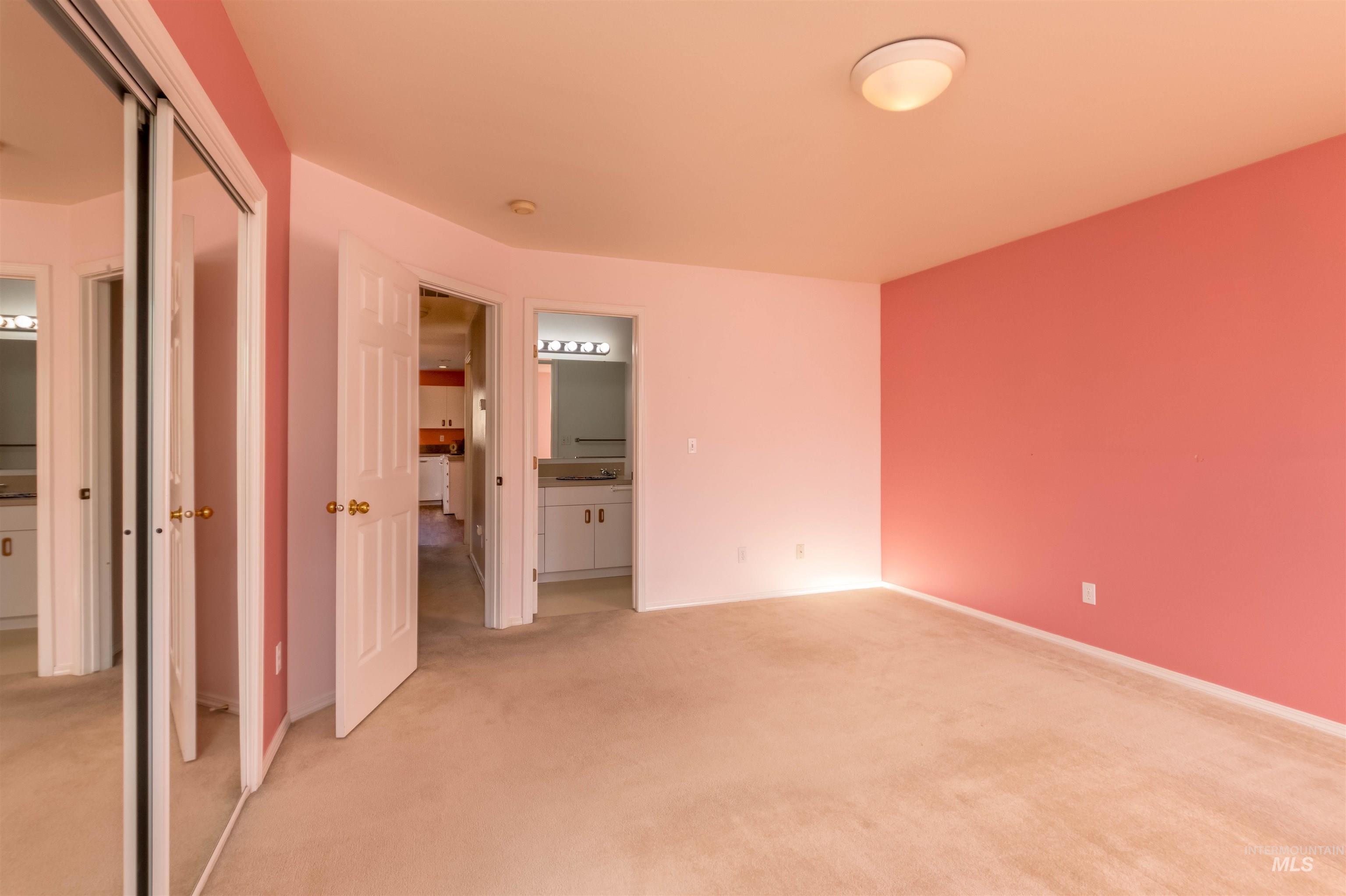 1811 Cleveland Street Boise, ID 83705 - Photo 14 of 30 Unfurnished bedroom featuring ensuite bathroom, a closet, and light carpet
