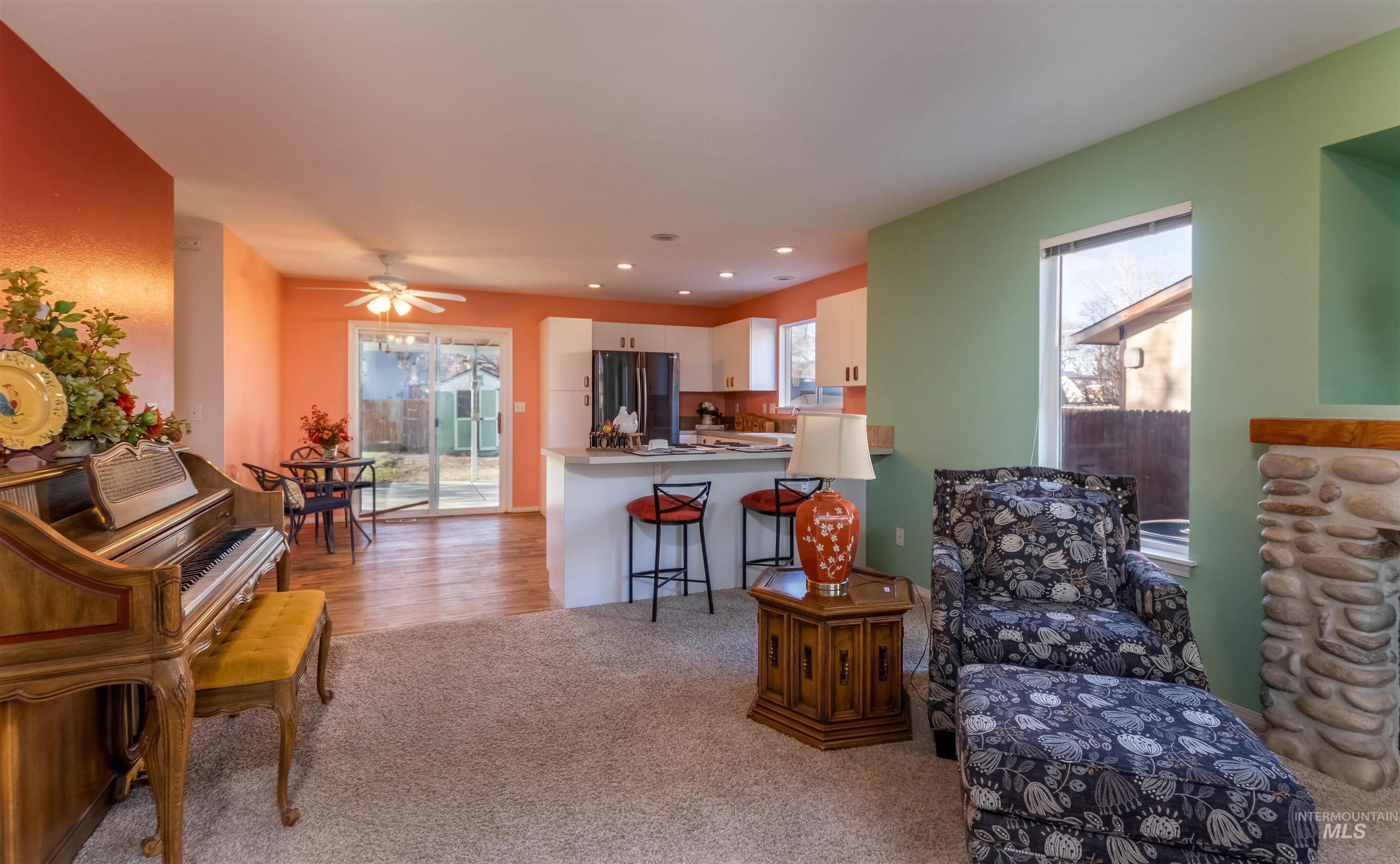 1811 Cleveland Street Boise, ID 83705 - Photo 5 of 30 Living area with light carpet, healthy amount of natural light, and a ceiling fan