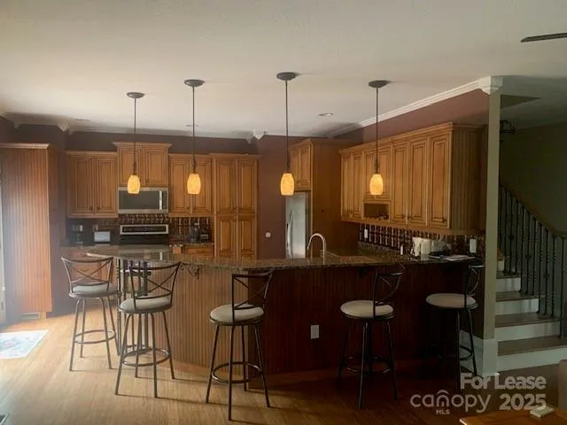 a kitchen with a table chairs stove and cabinets