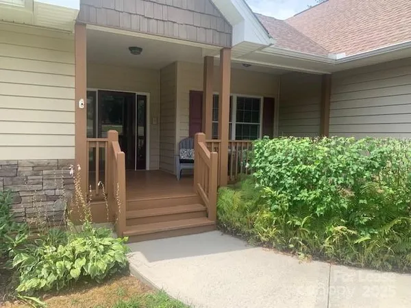 a view of a house with potted plants