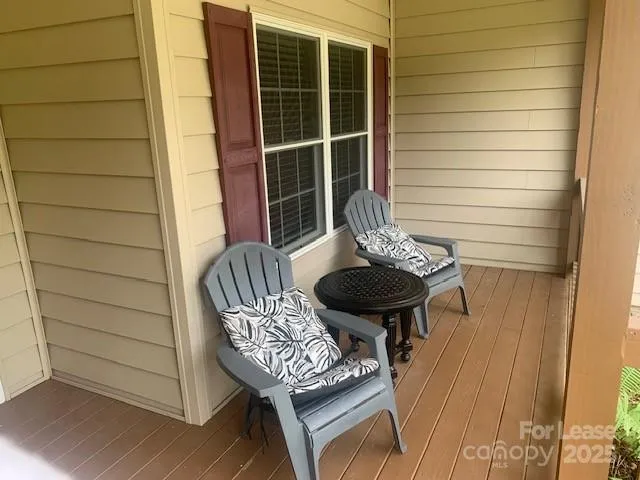 a view of a house with a chairs and table in a patio
