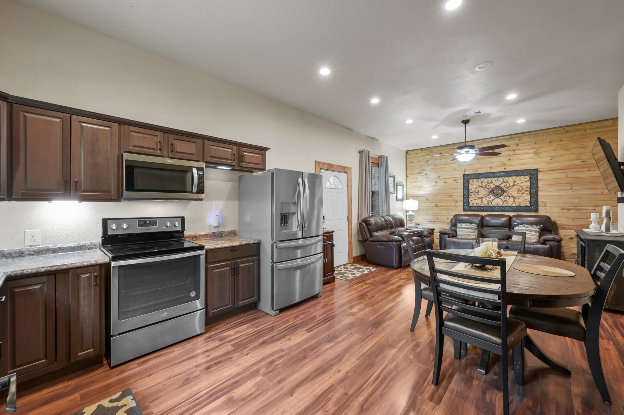 15306 Rabon Chapel Road Montgomery, TX 77316 - Photo 17 of 48 a kitchen with a table chairs microwave and refrigerator