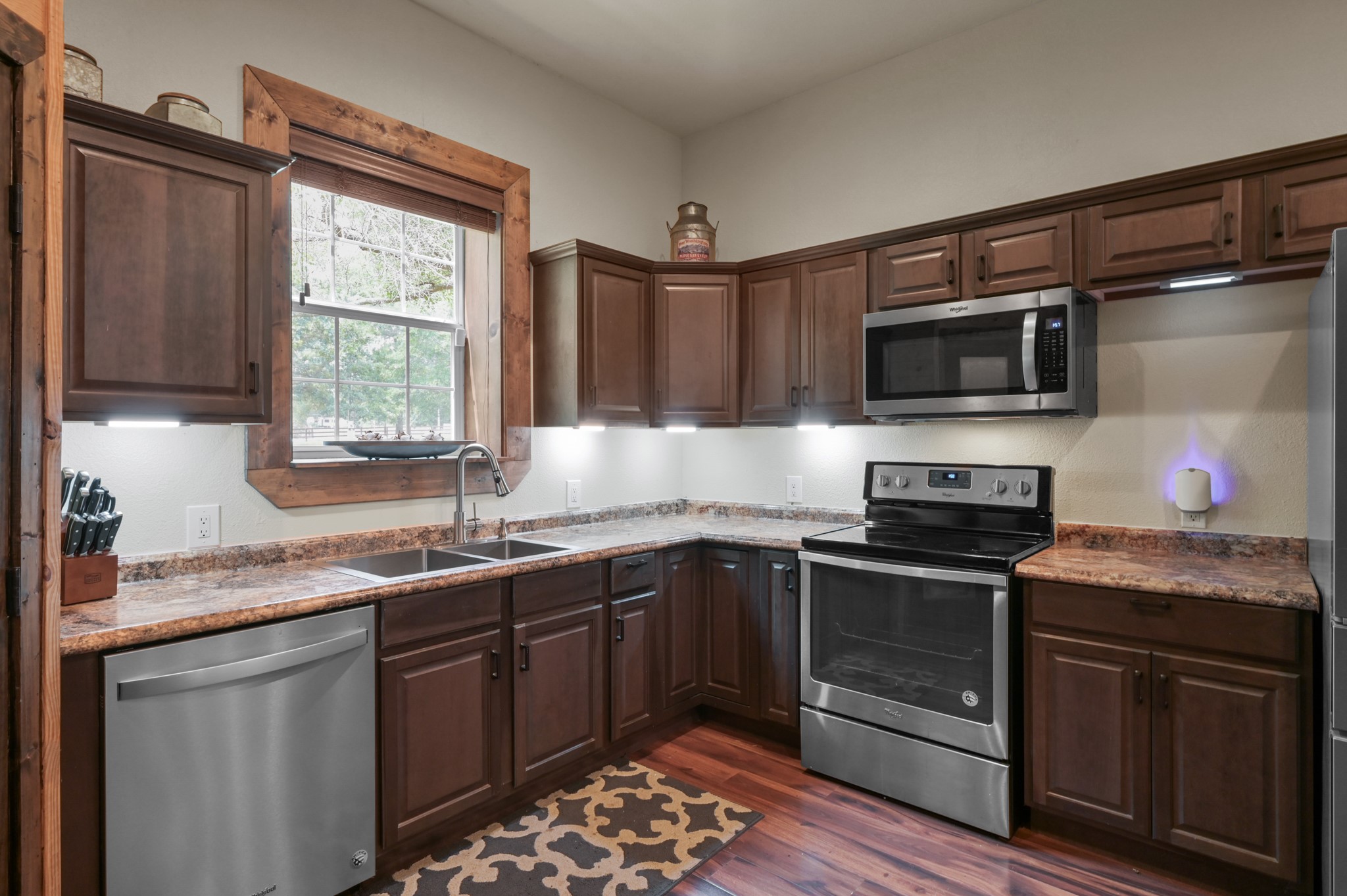 15306 Rabon Chapel Road Montgomery, TX 77316 - Photo 19 of 48 a kitchen with stainless steel appliances granite countertop a sink stove microwave and refrigerator