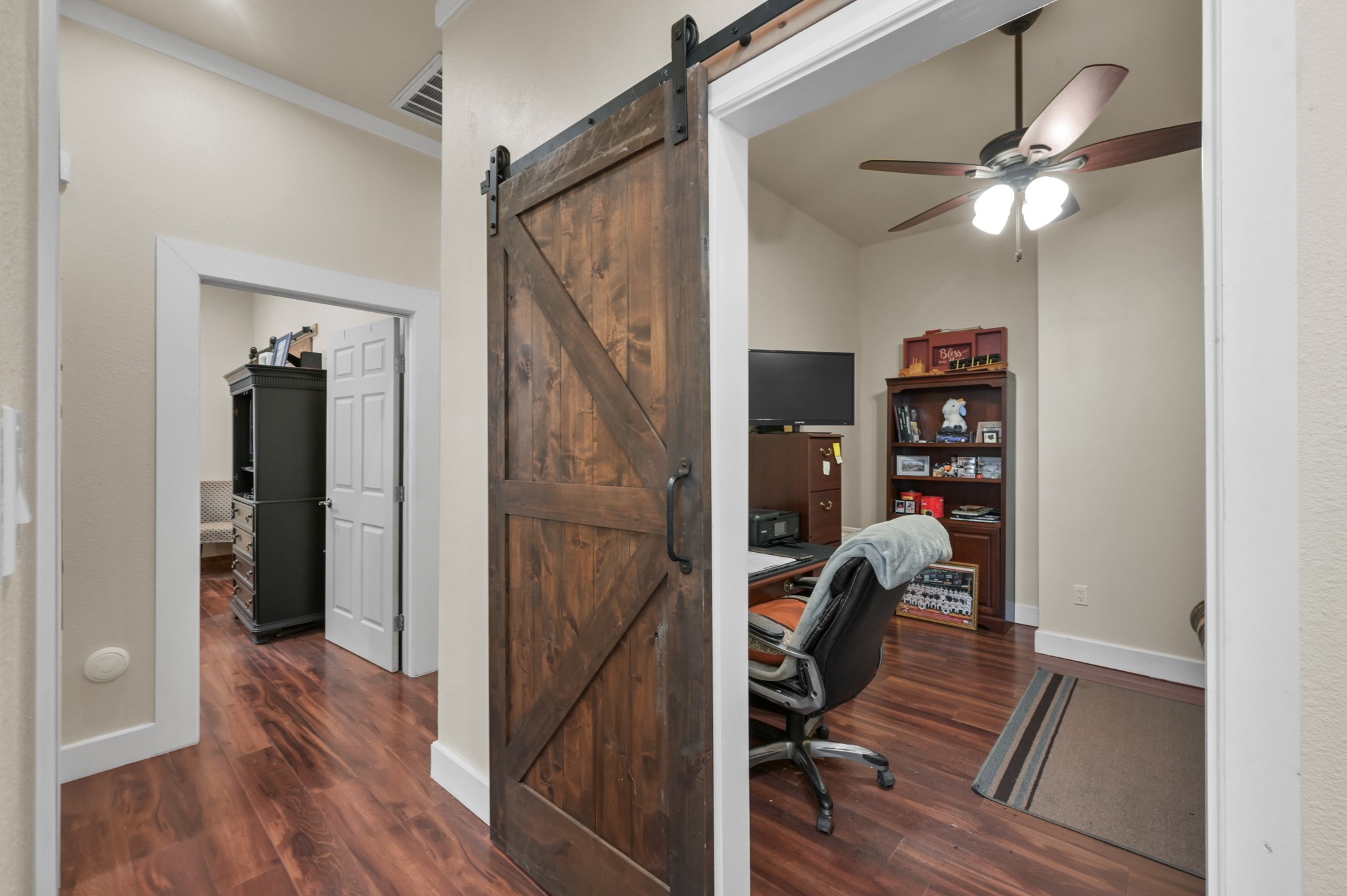 15306 Rabon Chapel Road Montgomery, TX 77316 - Photo 21 of 48 a view of a hallway with wooden floor and workspace