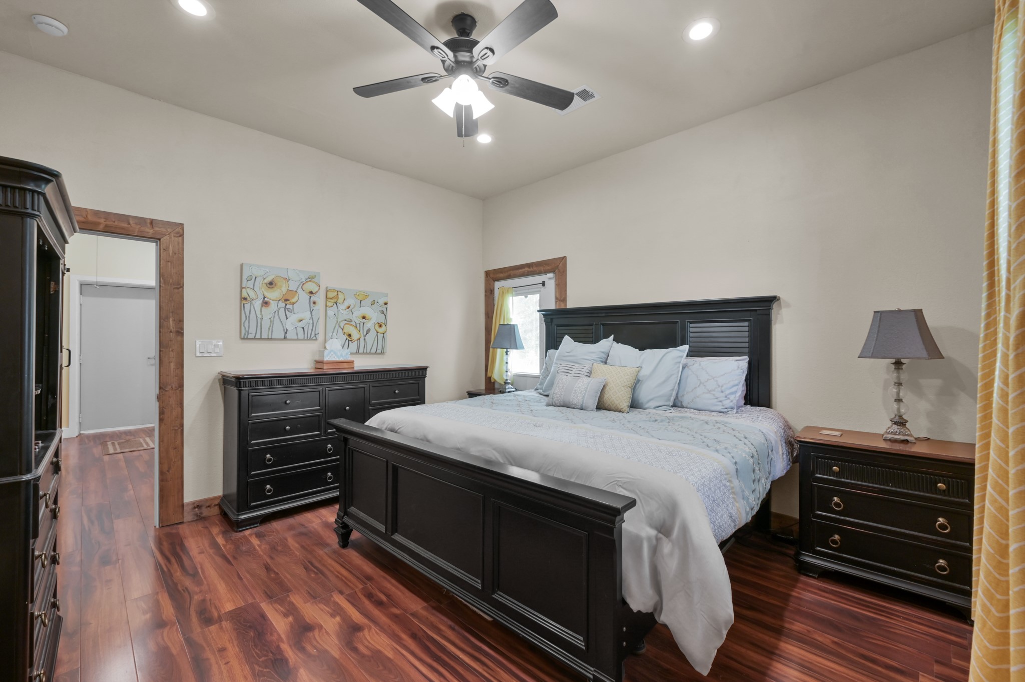 15306 Rabon Chapel Road Montgomery, TX 77316 - Photo 25 of 48 a bedroom with a bed and a chandelier