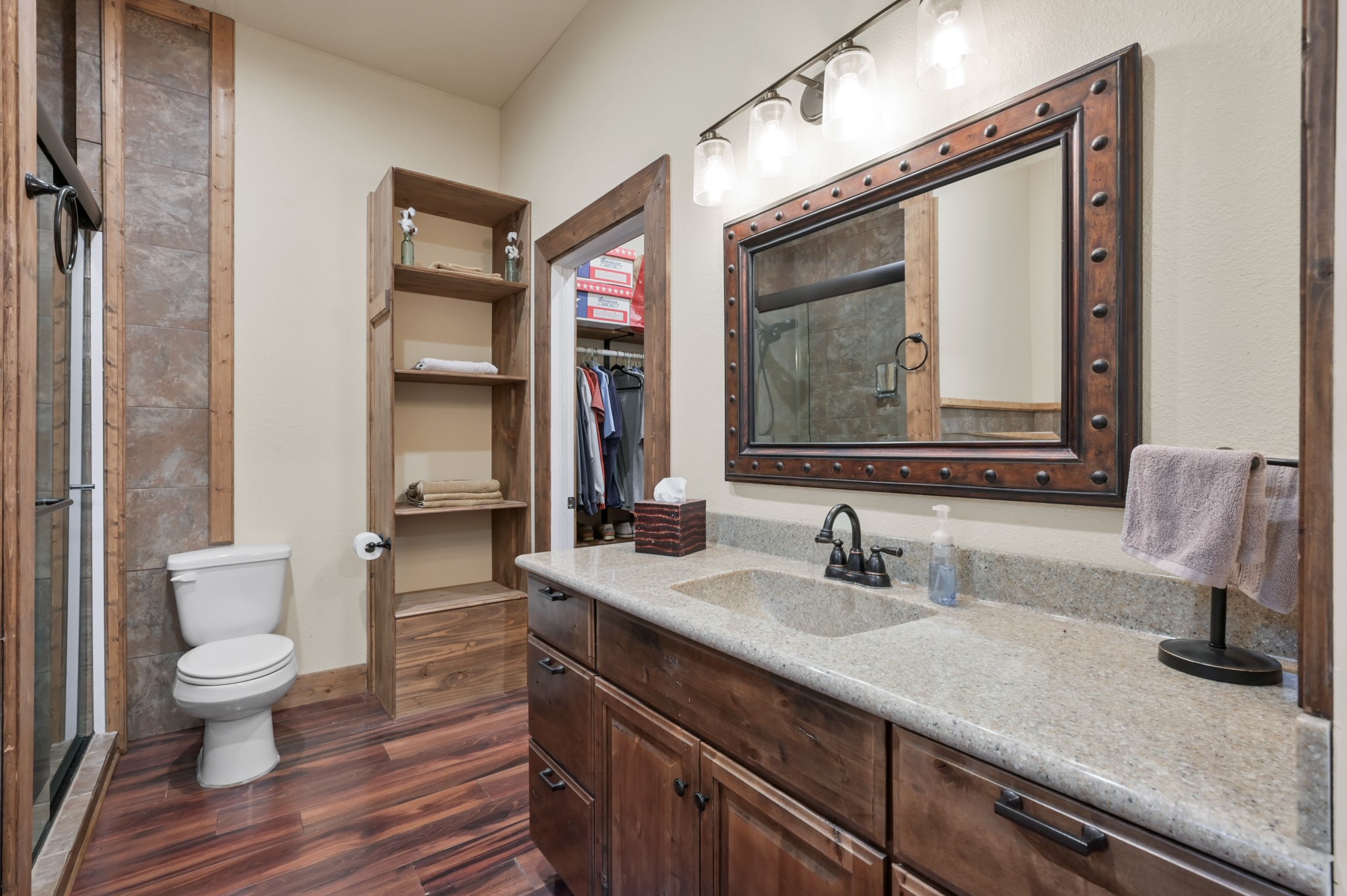 15306 Rabon Chapel Road Montgomery, TX 77316 - Photo 27 of 48 a bathroom with a toilet sink and mirror