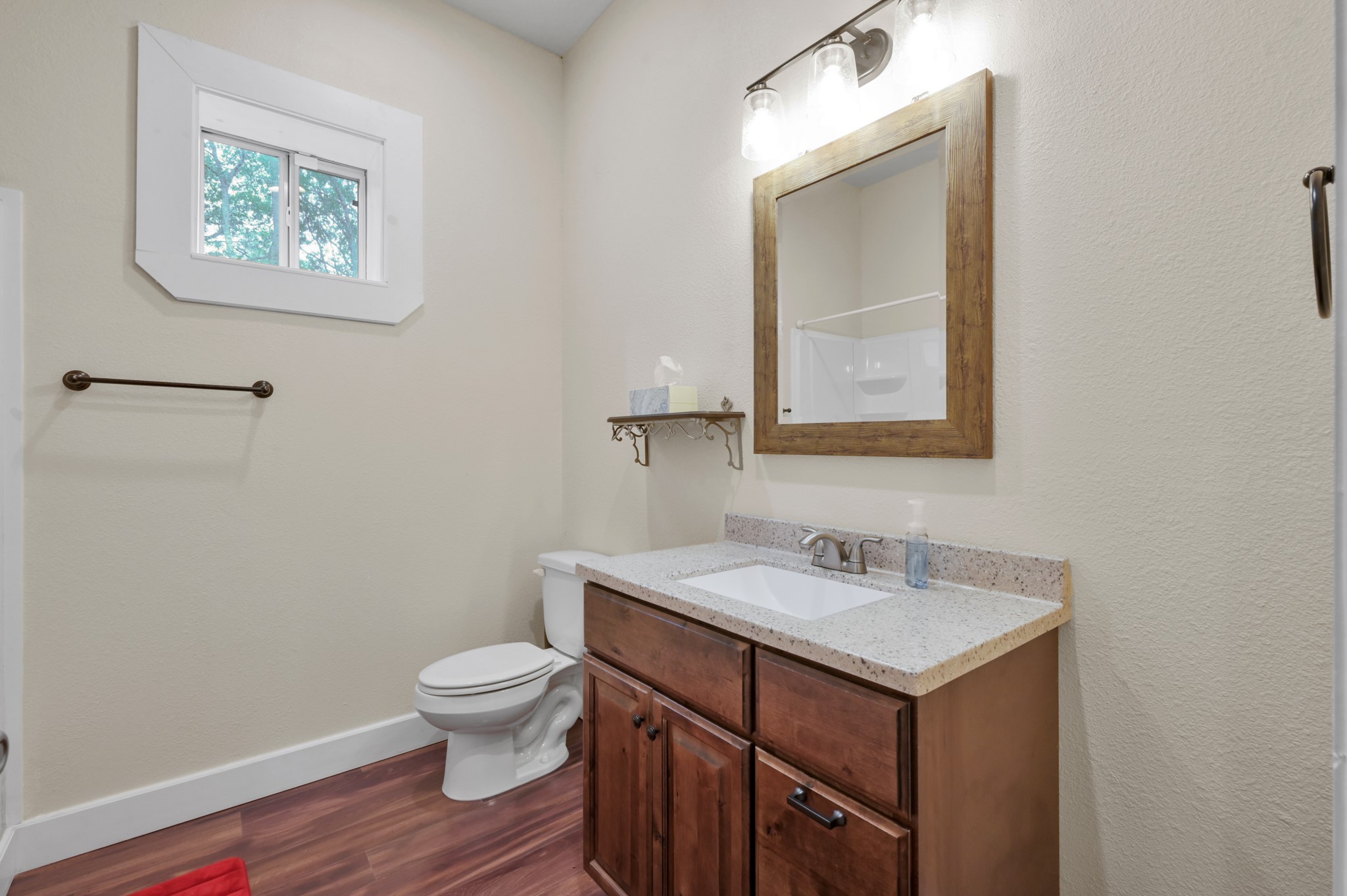 15306 Rabon Chapel Road Montgomery, TX 77316 - Photo 31 of 48 a bathroom with a toilet a sink and mirror