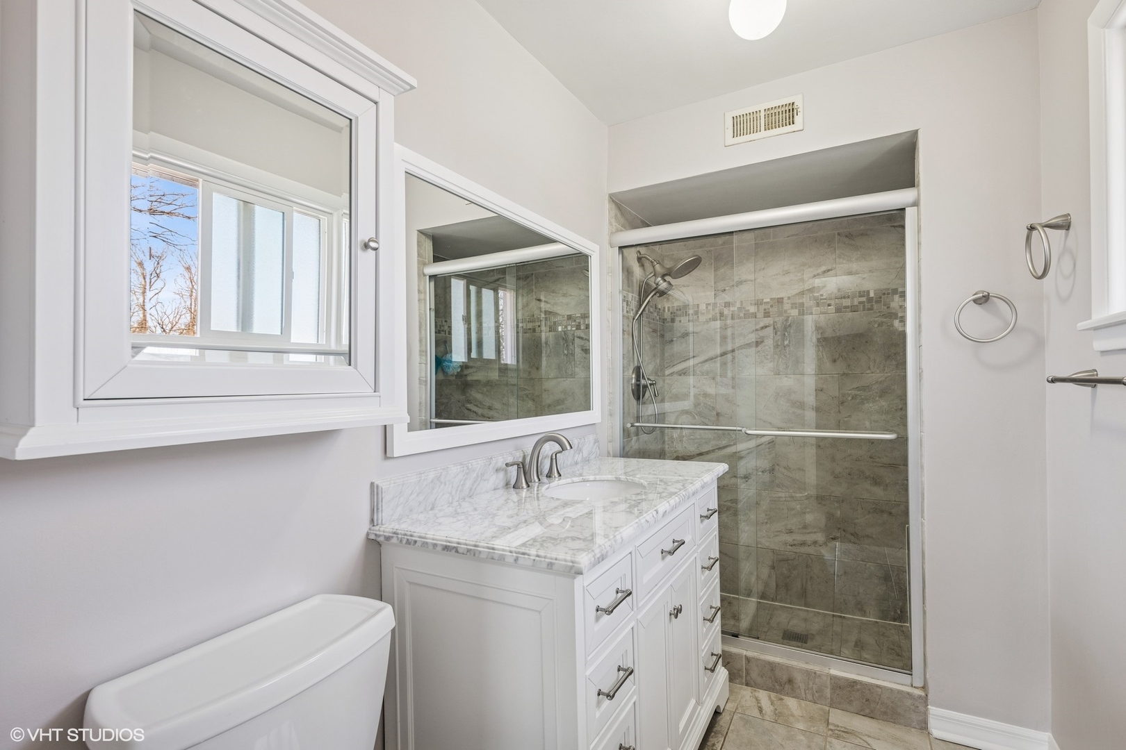 761 Kipling Place Deerfield, IL 60015 - Photo 14 of 27 a bathroom with a granite countertop sink a toilet and shower