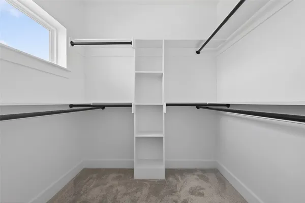 a bedroom with a bed and a lamp