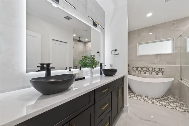 a bathroom with a white bath tub and a shower
