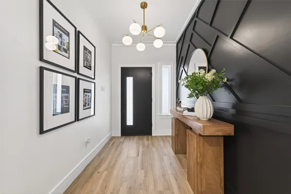 a view of a hallway with wooden floor and staircase