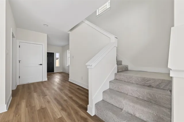 a view of an entryway with wooden floor