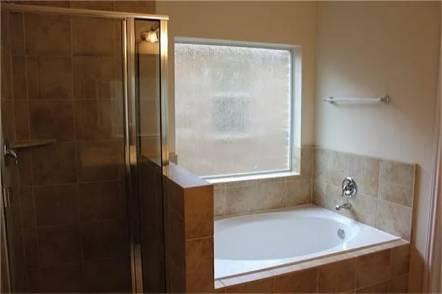 a bathroom with a bathtub and shower