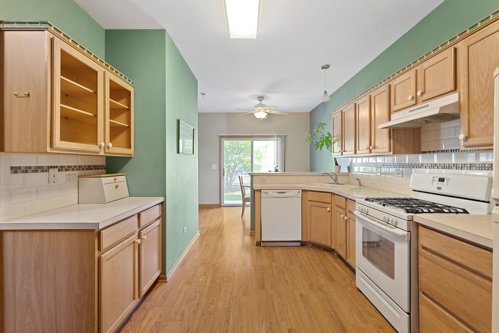 17537 Gilbert Drive Lockport, IL 60441 - Photo 6 of 16 a kitchen with a sink stove cabinets and wooden floor