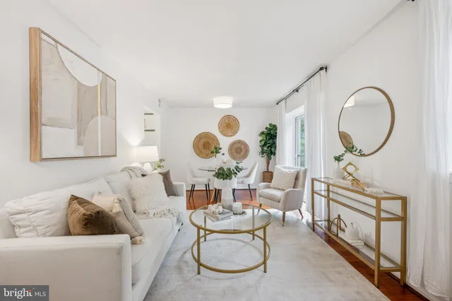 a living room with furniture and a mirror