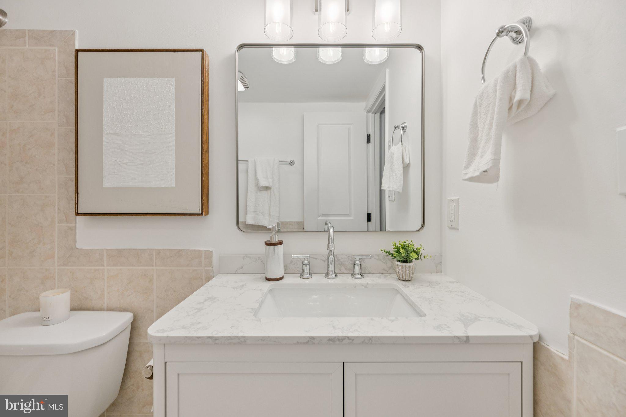 2630 Adams Mill Road Northwest, Unit 103 Washington, DC 20009 - Photo 12 of 24 a bathroom with a sink and a mirror
